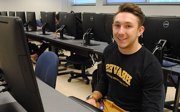 A person sitting in front of a computer